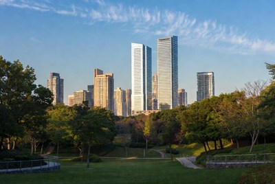 Skyscrapers over green park