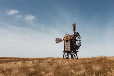 Windmill in golden grassland
