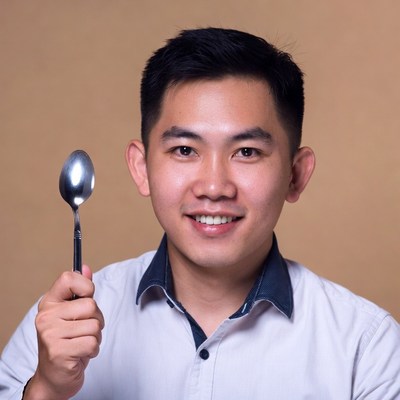 Asian man holding spoon