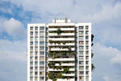 White Apartment Building with Balcony Plants
