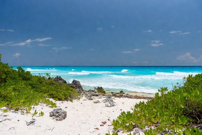 Turquoise ocean waves crashing on rocky beach