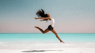 Woman jumping on beach