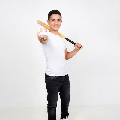Boy holding baseball bat and ball