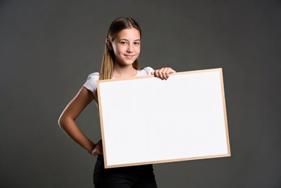 Teen girl holding blank whiteboard