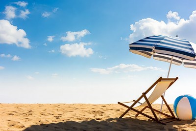 Beach chair under striped umbrella