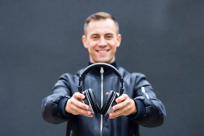 Man holding black headphones