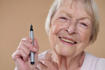 Elderly woman holding marker