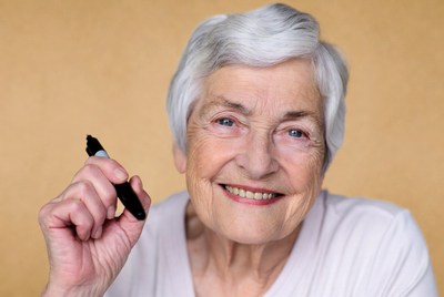 Elderly woman holding black marker