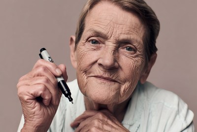 Elderly woman holding marker