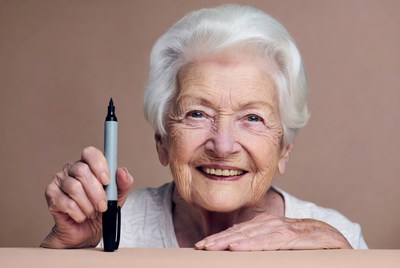 Elderly woman holding marker