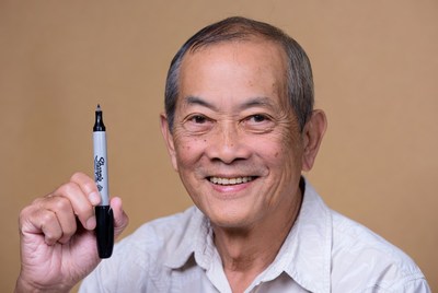 Asian man holding Sharpie marker