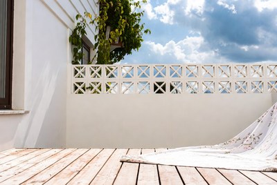 White Wooden Balcony with Floral Blanket