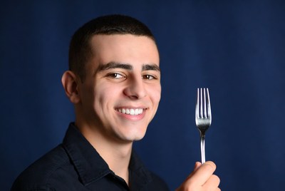Smiling man holding fork