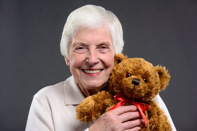Elderly woman holding teddy bear