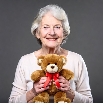 Elderly woman holding teddy bear