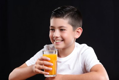 Boy drinking orange juice