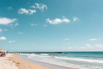 Pier extending over sunny beach