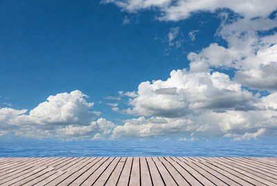 Wooden pier over ocean blue sky