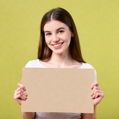 Smiling woman holding blank sign