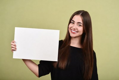 Smiling woman holding blank sign