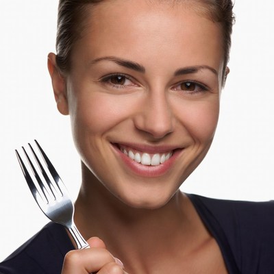 Smiling woman holding fork