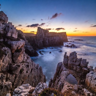 Cliff Arch at Sunset Over Ocean