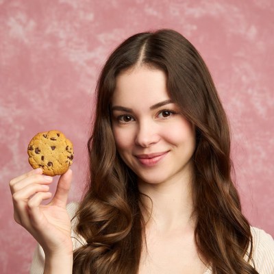 Woman holding chocolate chip cookie