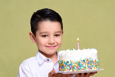 Boy holding birthday cake