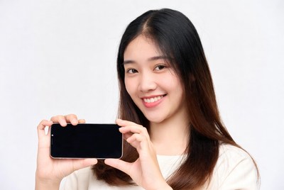 Asian woman holding blank smartphone