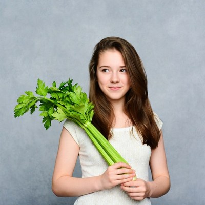 Girl holding fresh celery