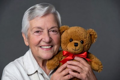 Elderly woman holding teddy bear