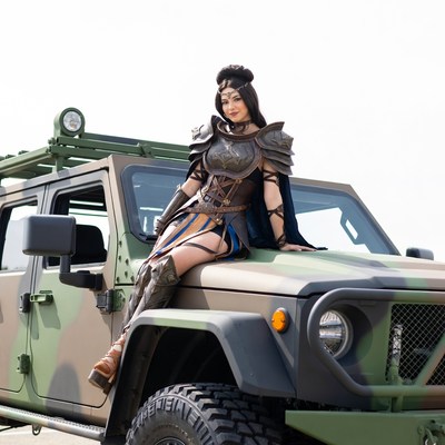 Woman in fantasy armor on military jeep