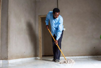 African man mopping floor