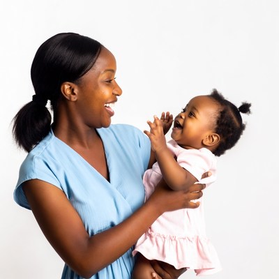 African-American mother holding laughing baby