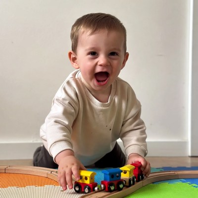 Baby boy playing with toy trains