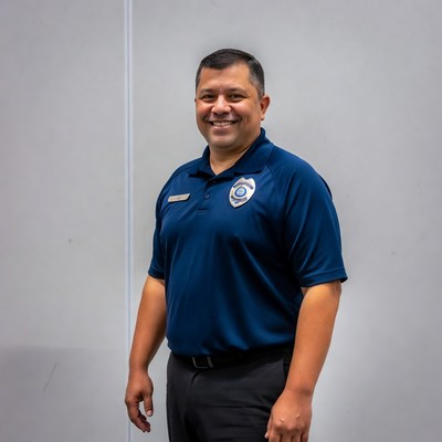 Latino police officer smiling