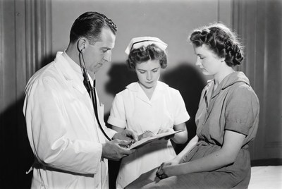 Doctor and Nurses Examining Patient