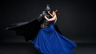 Batman dancing with woman in blue gown