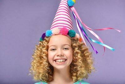 Girl wearing colorful party hat
