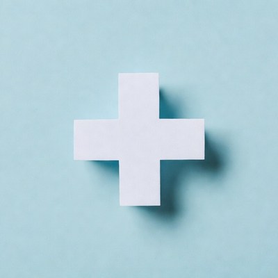 White paper plus sign on blue