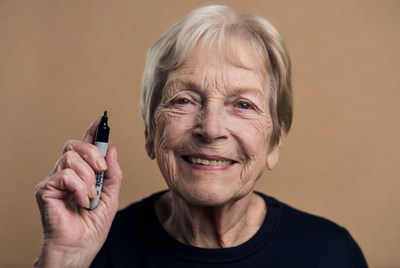 Elderly woman holding marker
