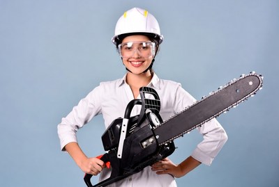 Asian woman holding chainsaw
