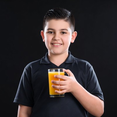 Boy holding glass of orange juice