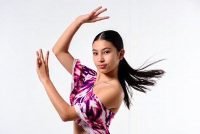 Asian girl dancing in pink ruffle top