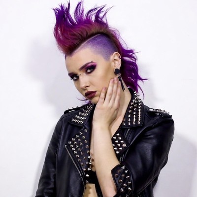 Woman with purple mohawk and studded jacket