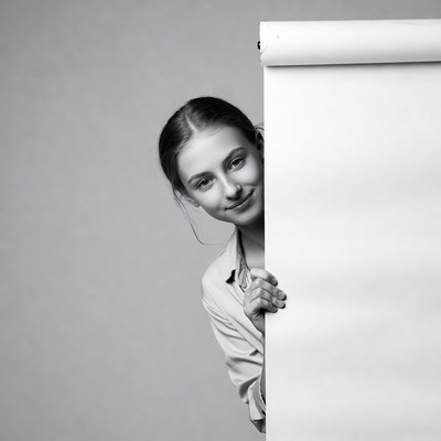 Girl peeking from behind paper roll