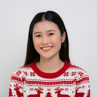 Asian woman smiling in reindeer Christmas sweater