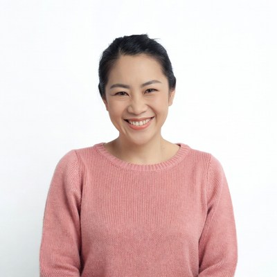 Smiling Asian woman in pink sweater