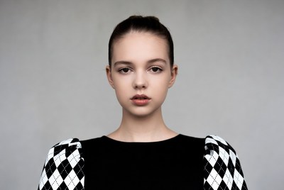 Teen girl in black houndstooth sleeve top