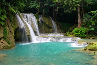 Multi-tiered waterfall cascading into turquoise pool